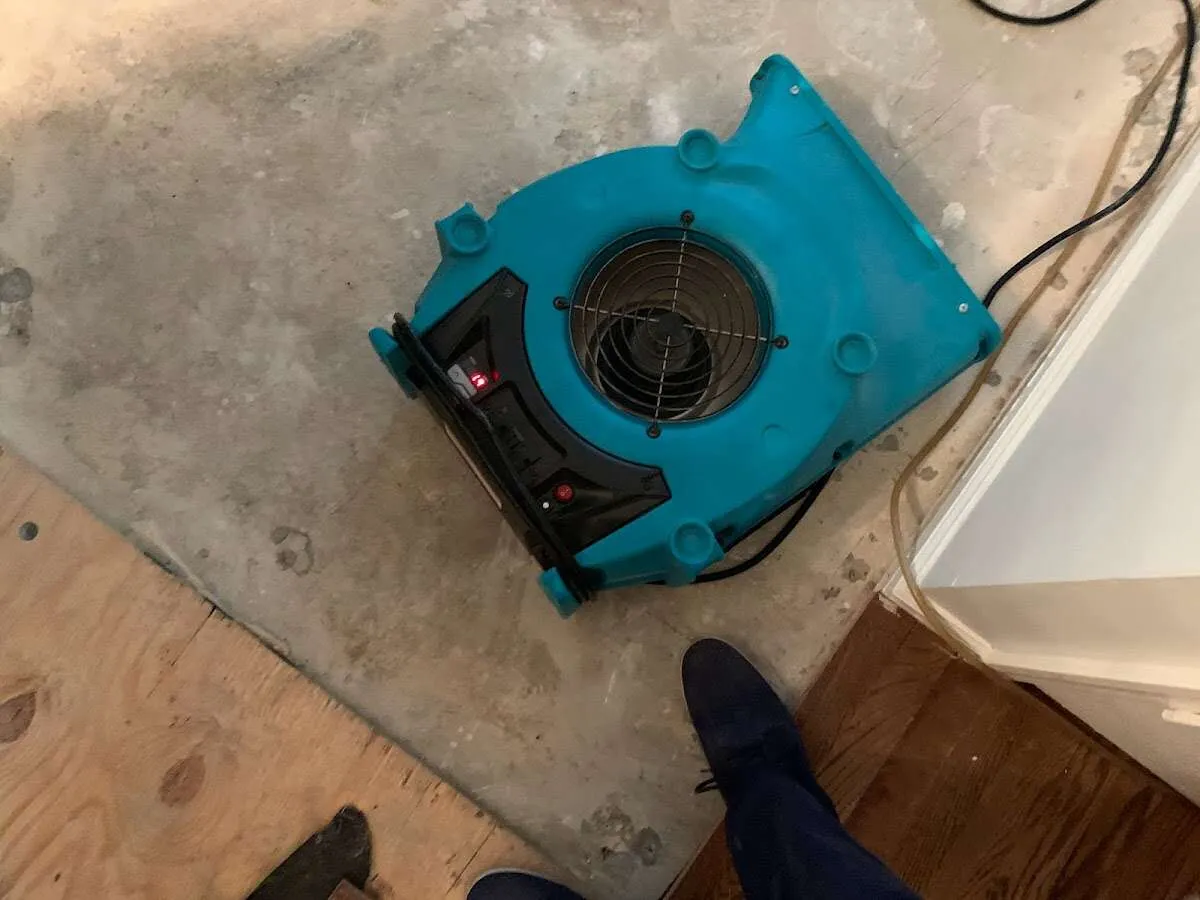 Air mover drying subfloor during Commercial Water Damage Restoration in Bullskin
